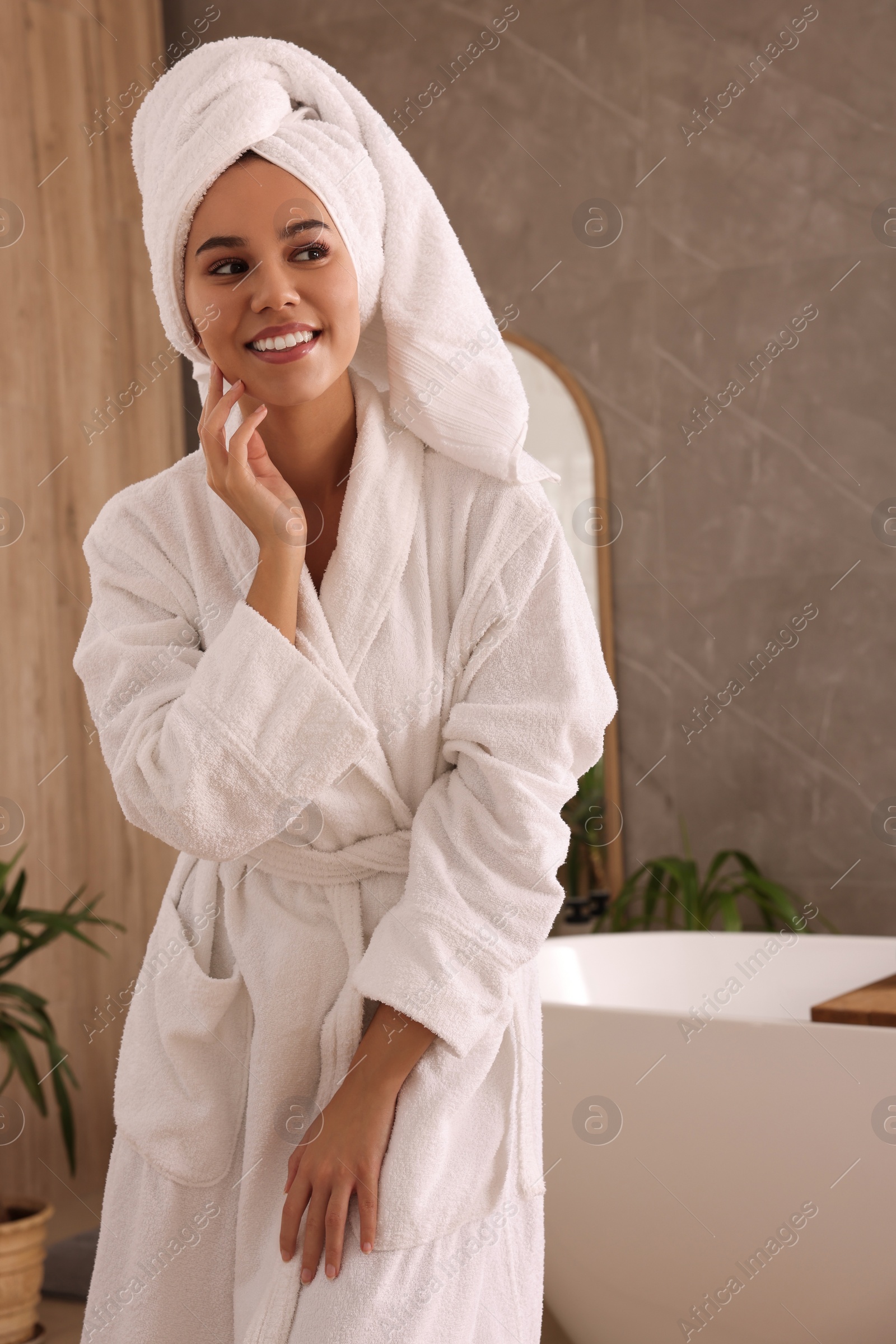 Photo of Beautiful African American woman near tub in bathroom