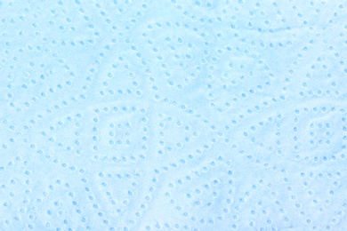 Perforated toilet paper as background, closeup. Personal hygiene