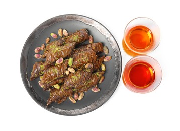 Photo of Delicious baklava with pistachios and hot tea on white background, top view