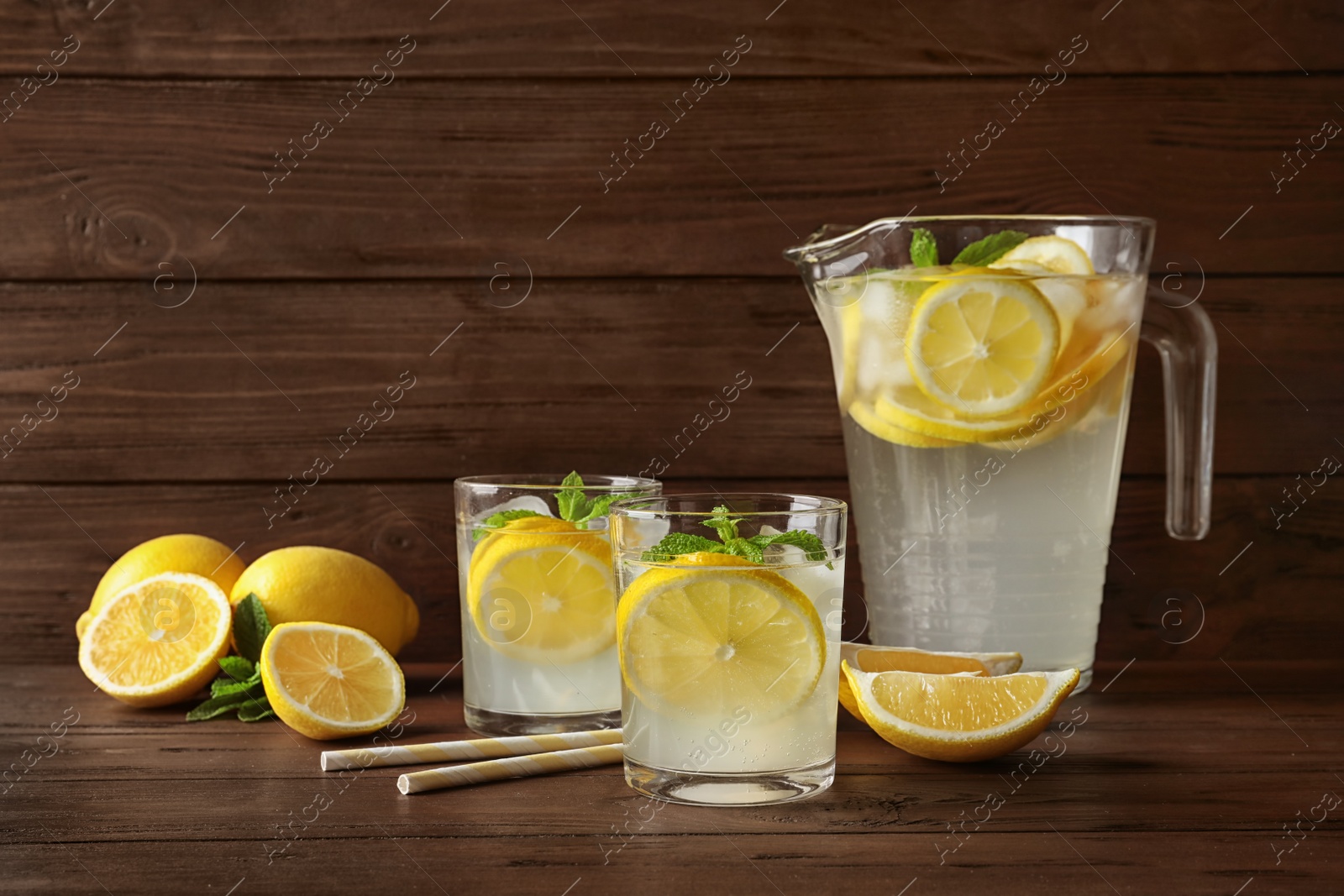 Photo of Glassware with natural lemonade on wooden table