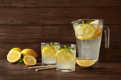 Glassware with natural lemonade on wooden table