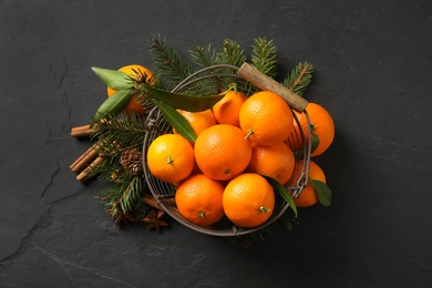 Photo of Christmas composition with tangerines on black background, flat lay