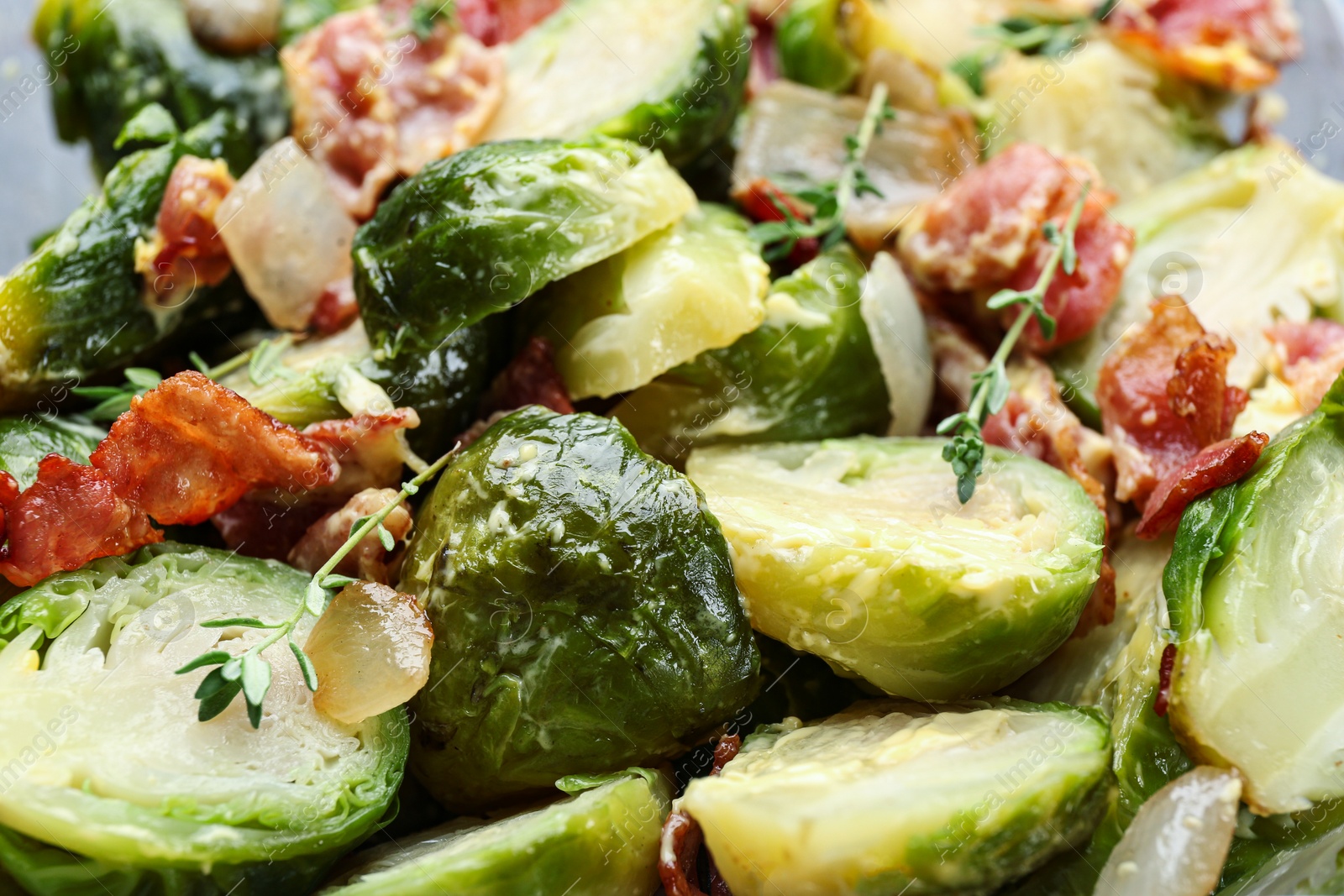 Photo of Delicious cooked Brussels sprouts with bacon, closeup