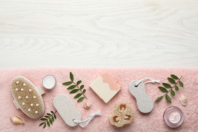 Flat lay composition with pumice stones on white wooden background. Space for text