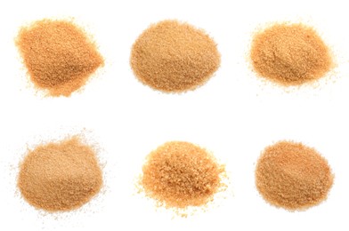 Piles of brown sugar on white background, top view