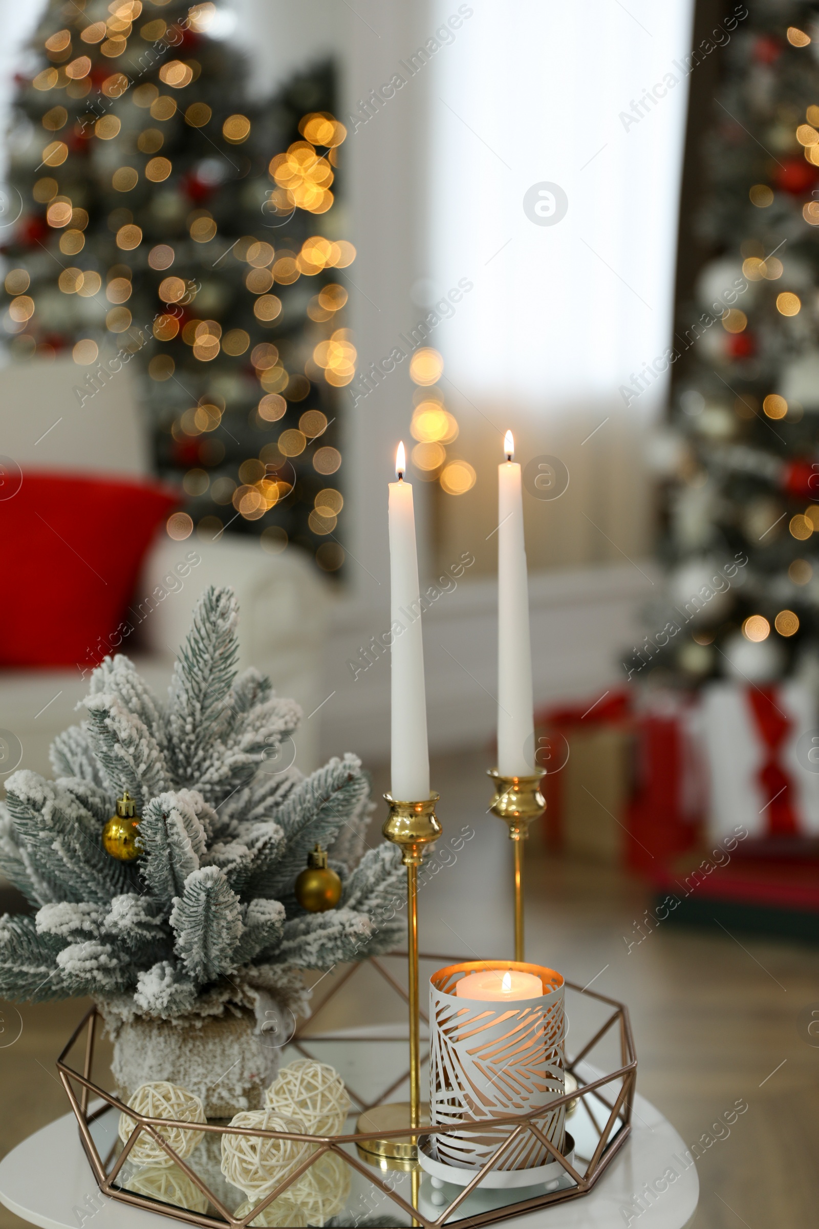 Photo of Beautiful Christmas composition with burning candles on table indoors