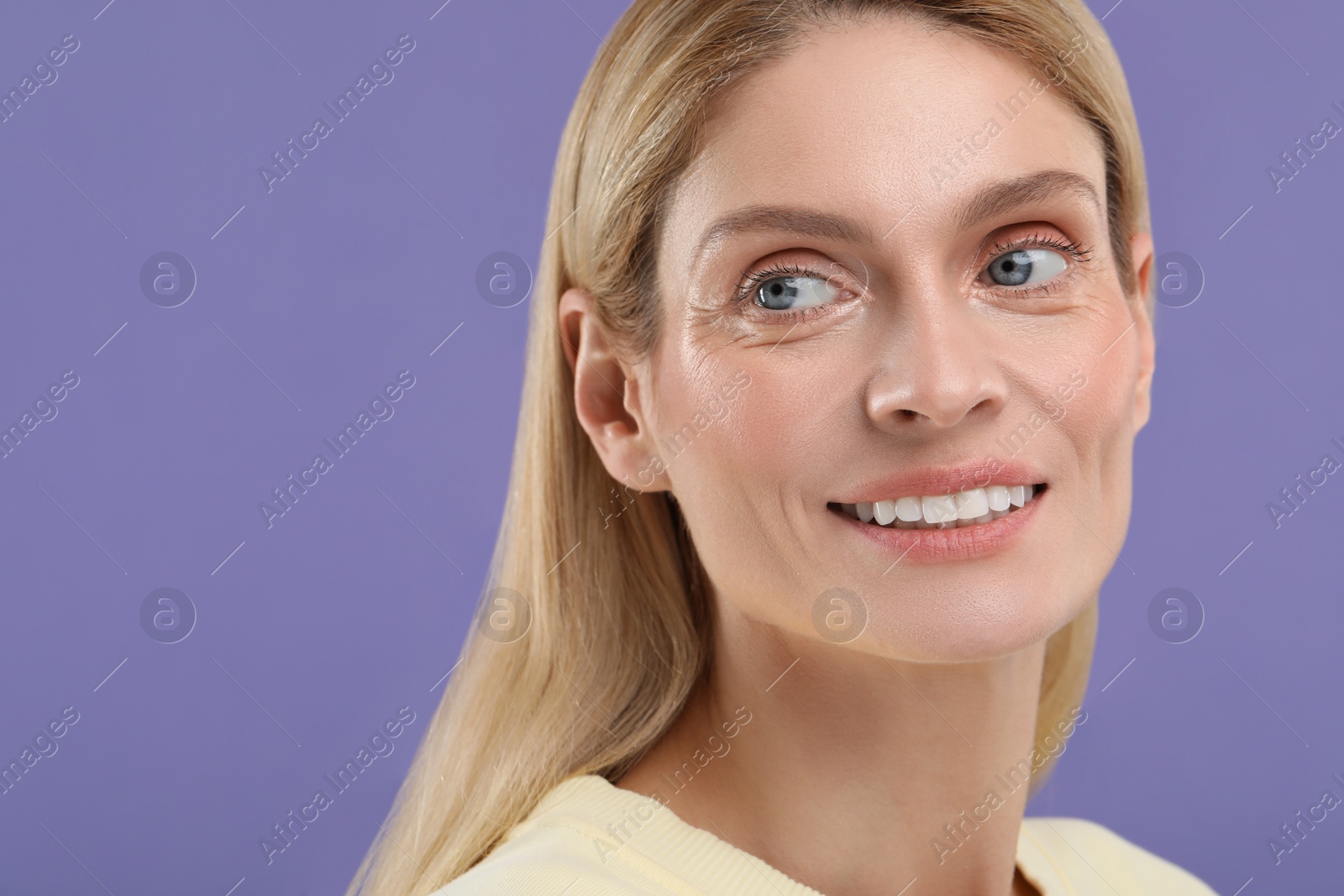 Photo of Woman with clean teeth smiling on violet background, space for text