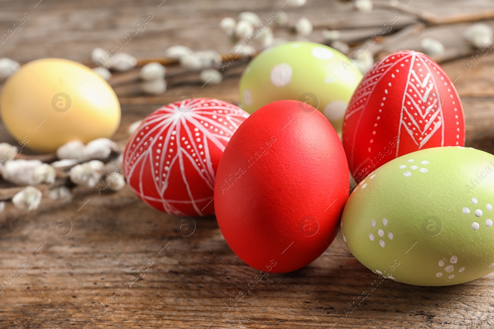 Photo of Colorful painted Easter eggs on wooden table