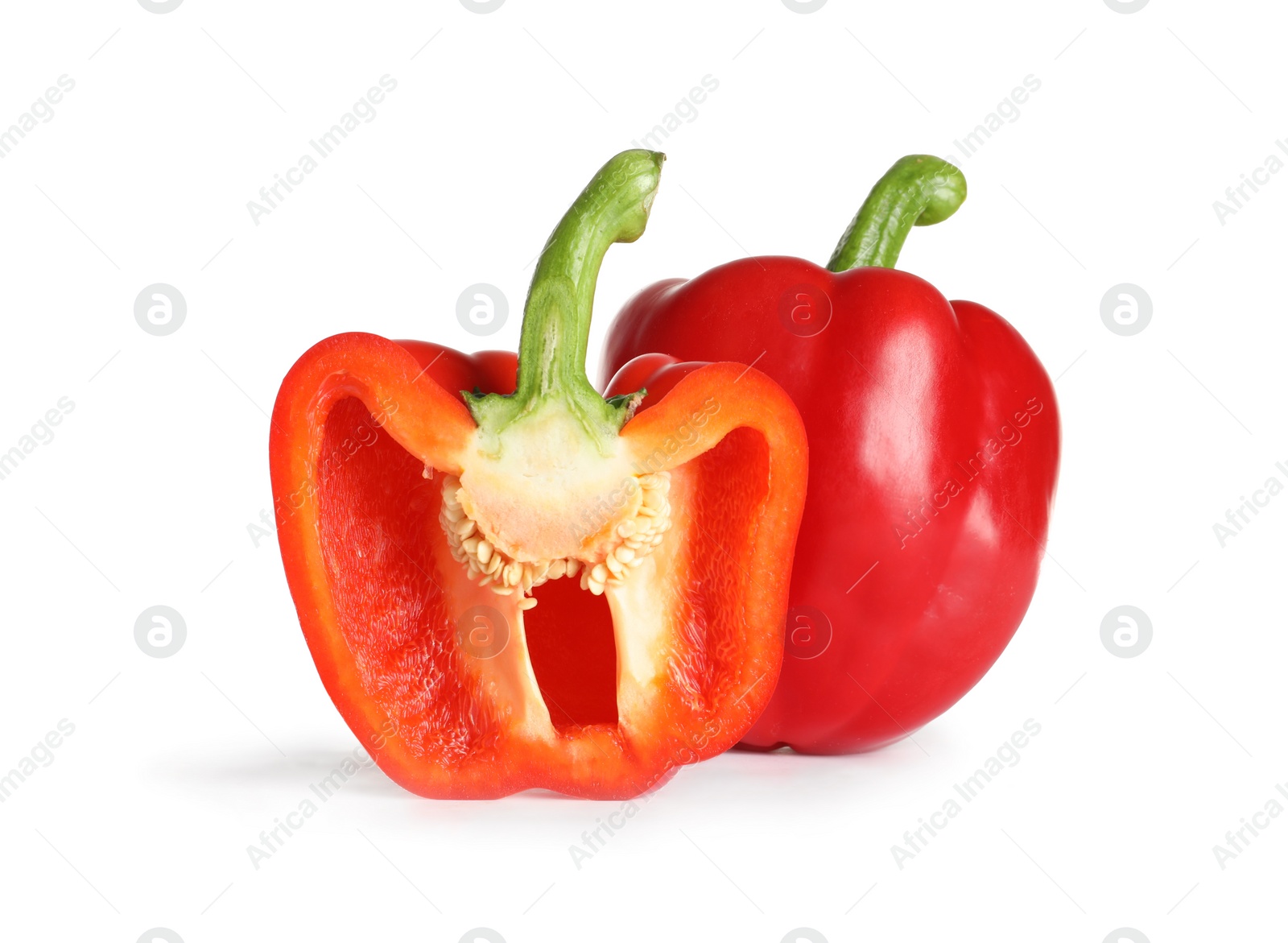 Photo of Cut and whole ripe red bell peppers on white background