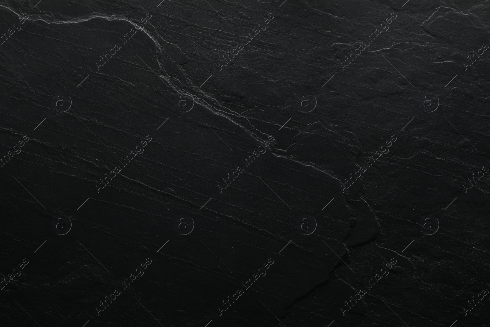 Photo of Texture of black surface as background, top view