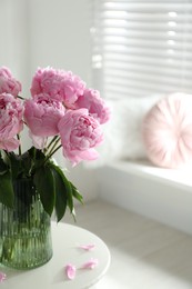 Bouquet of beautiful peonies on table indoors