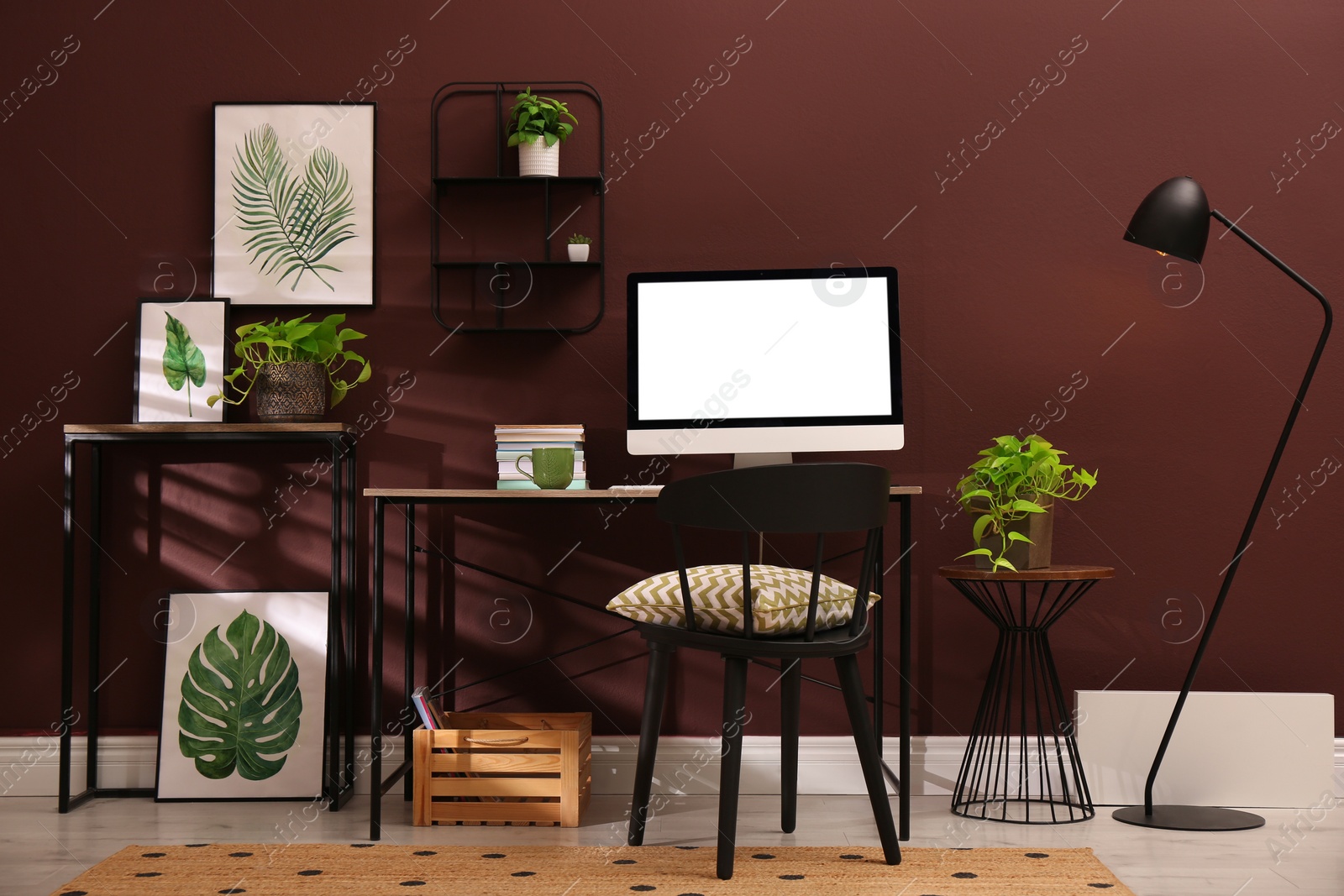 Photo of Comfortable workplace with modern computer and stylish furniture in room. Interior design