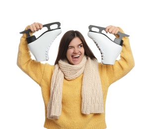 Emotional woman with ice skates on white background