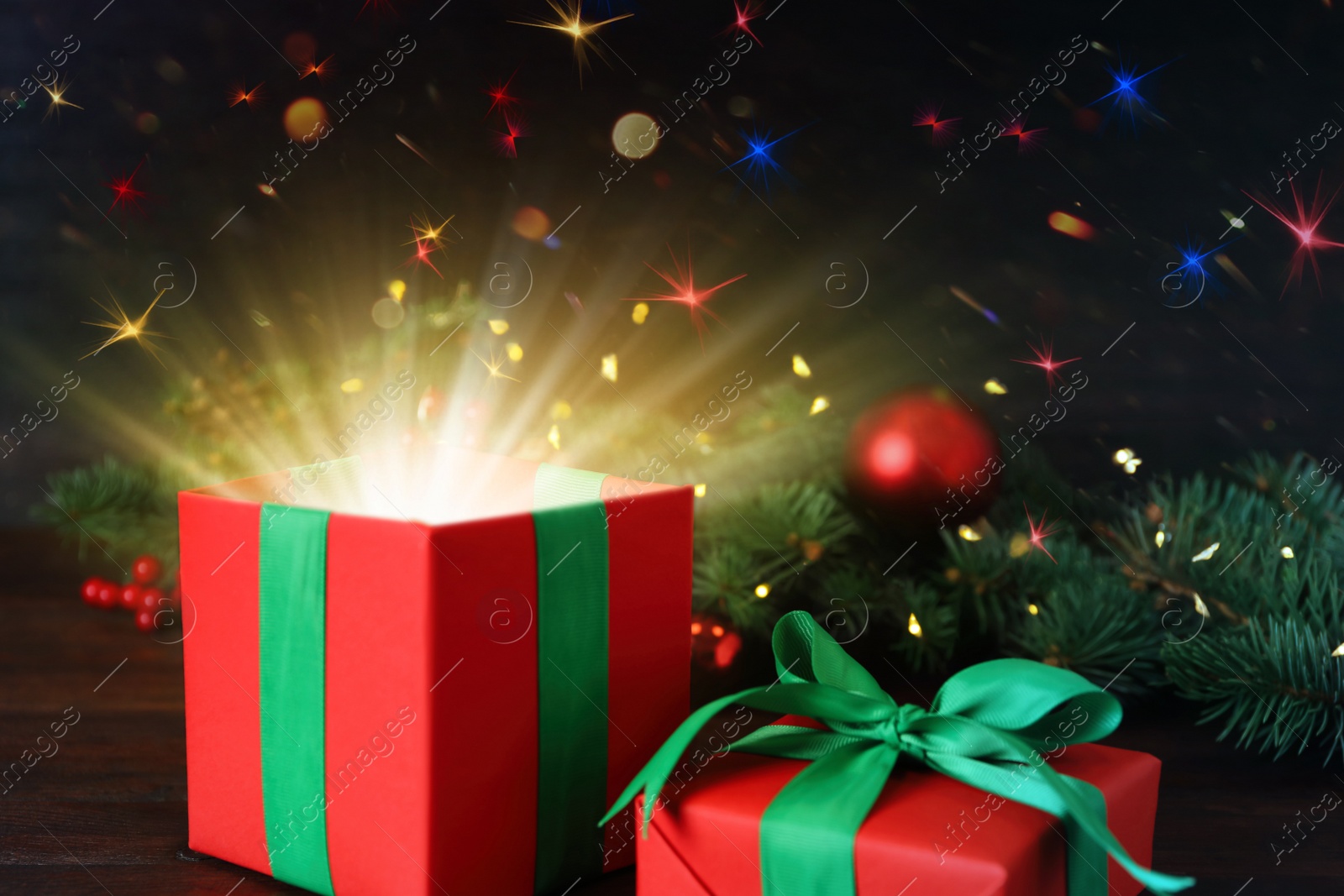 Image of Beautiful Christmas gift box with magic light on table