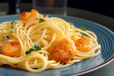 Delicious pasta with shrimps on plate, closeup