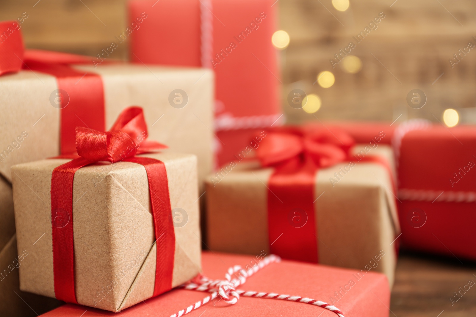 Photo of Christmas gifts against blurred lights, closeup. Boxing day