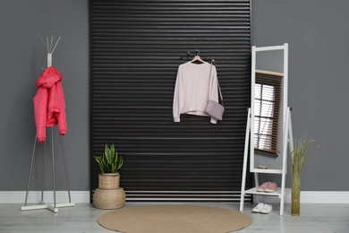 Hallway interior with stylish furniture, clothes and accessories