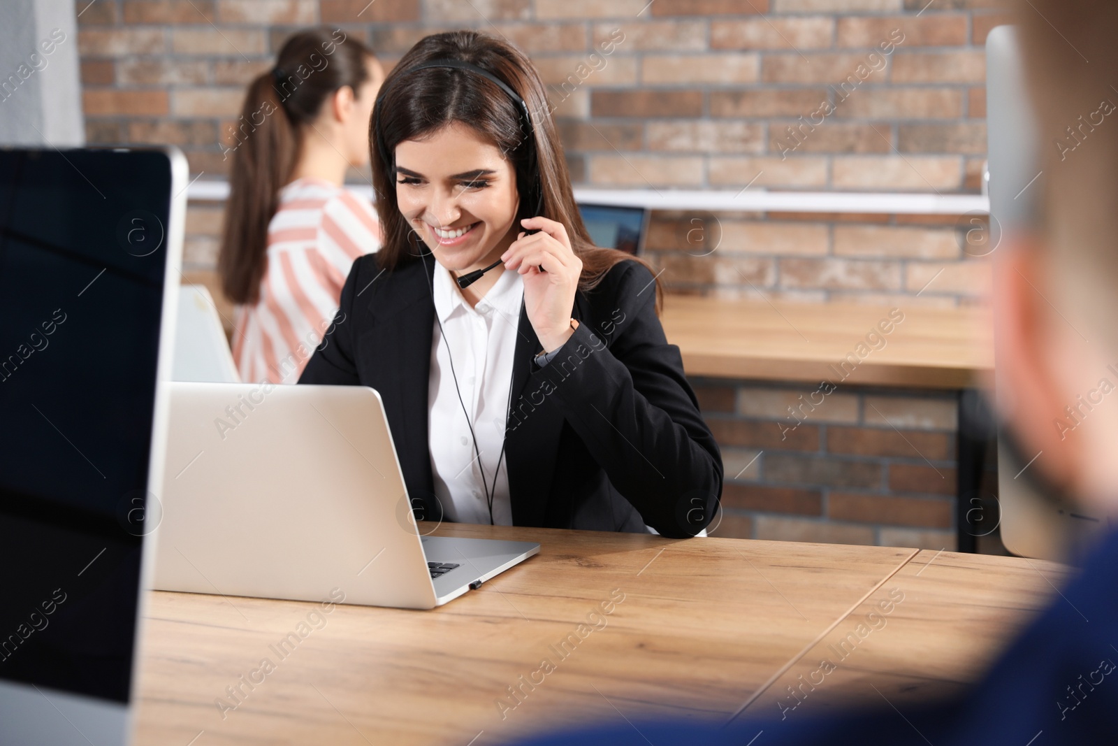 Photo of Technical support operator with headset in modern office