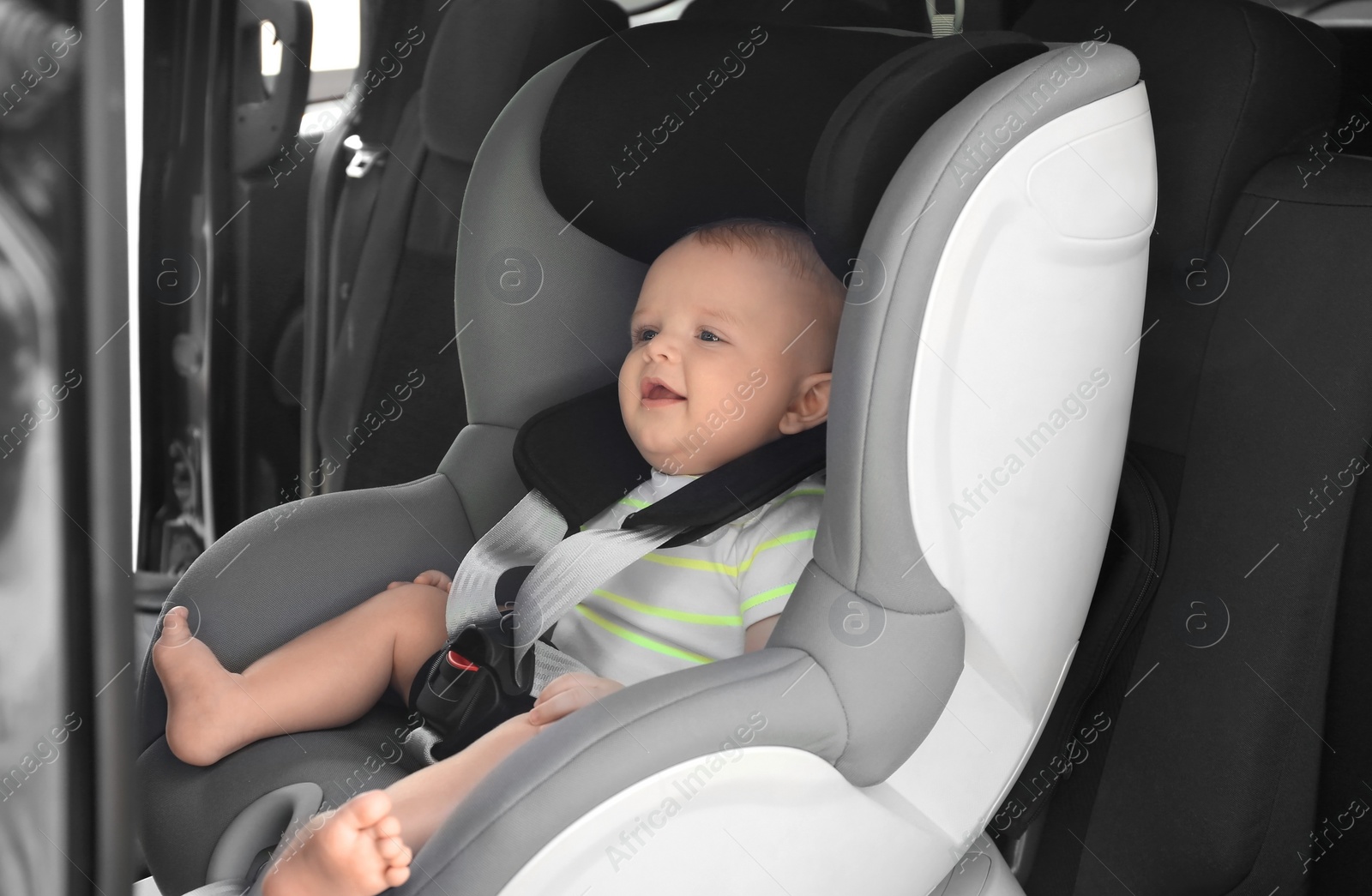 Photo of Little baby in child safety seat inside of car