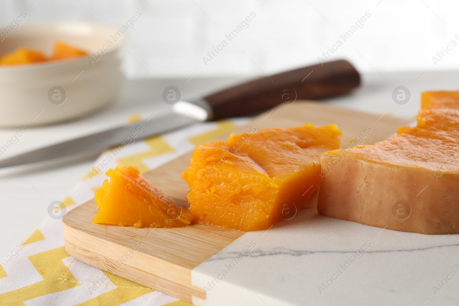 Photo of Pieces of boiled pumpkin on white table, closeup. Child's food