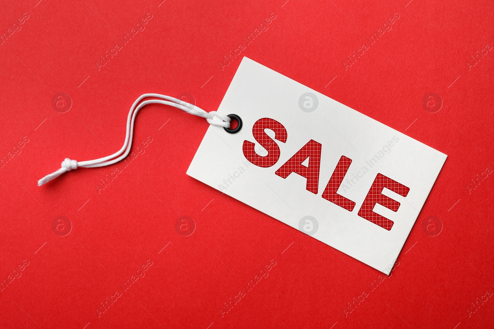 Image of Tag with text SALE on red background, top view. Black Friday 