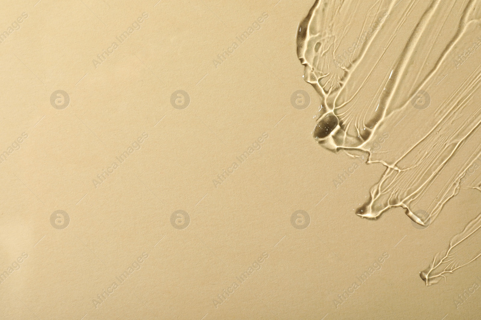 Photo of Transparent cosmetic gel on beige background, top view. Space for text