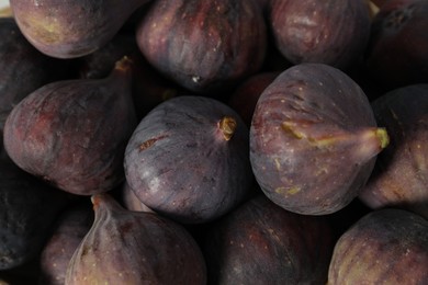 Photo of Tasty raw purple figs as background, closeup