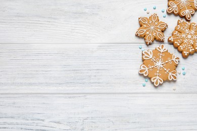 Tasty Christmas cookies on white wooden table, flat lay. Space for text