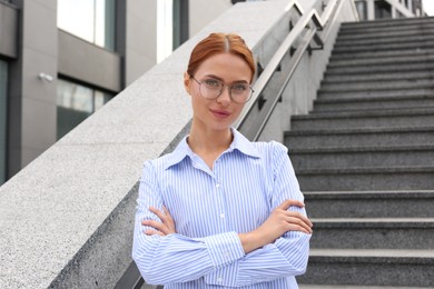 Photo of Portrait of beautiful woman in glasses outdoors