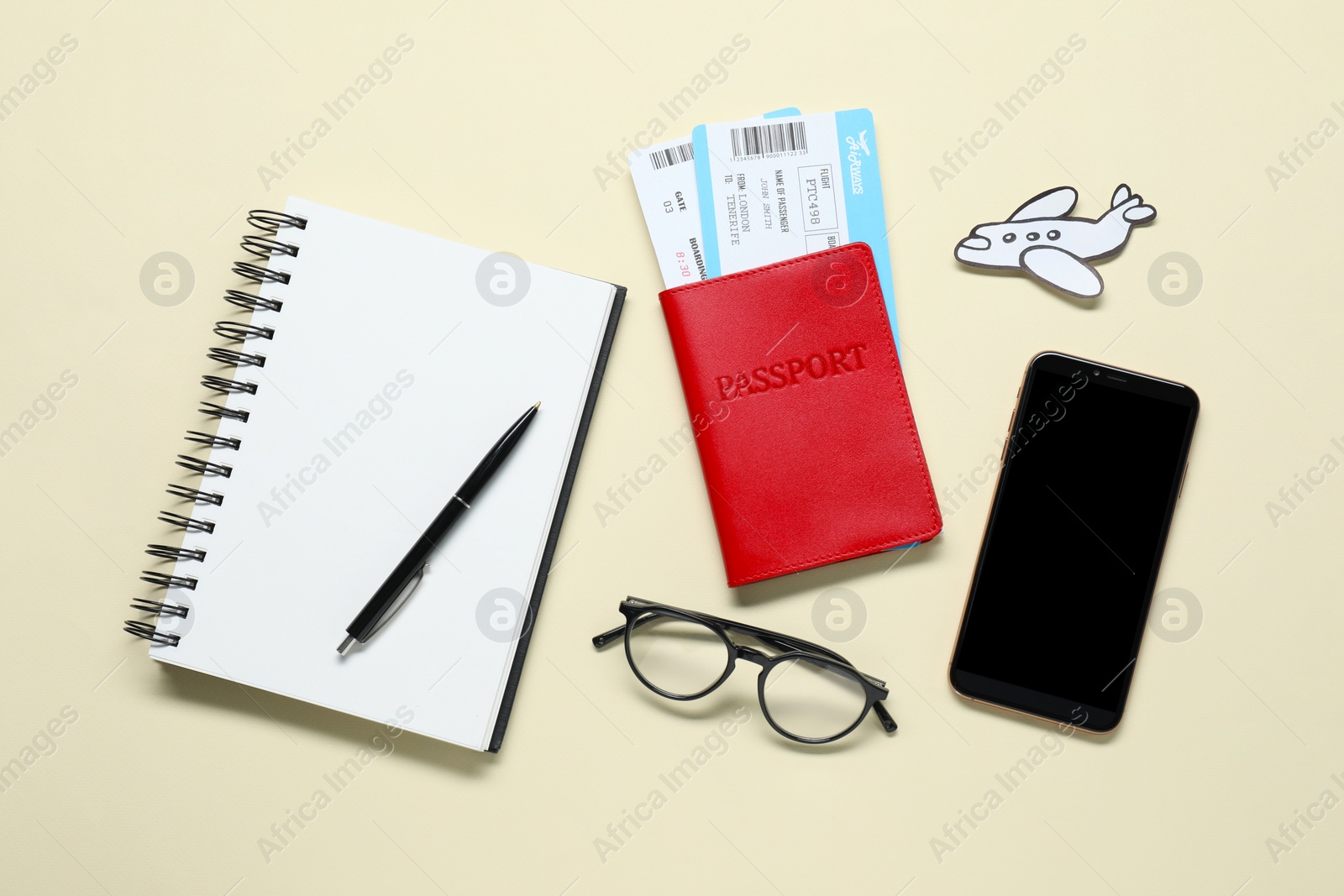 Photo of Flat lay composition with passport, notebook and tickets on beige table. Business trip