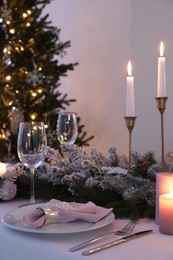 Beautiful festive table setting with Christmas decor indoors