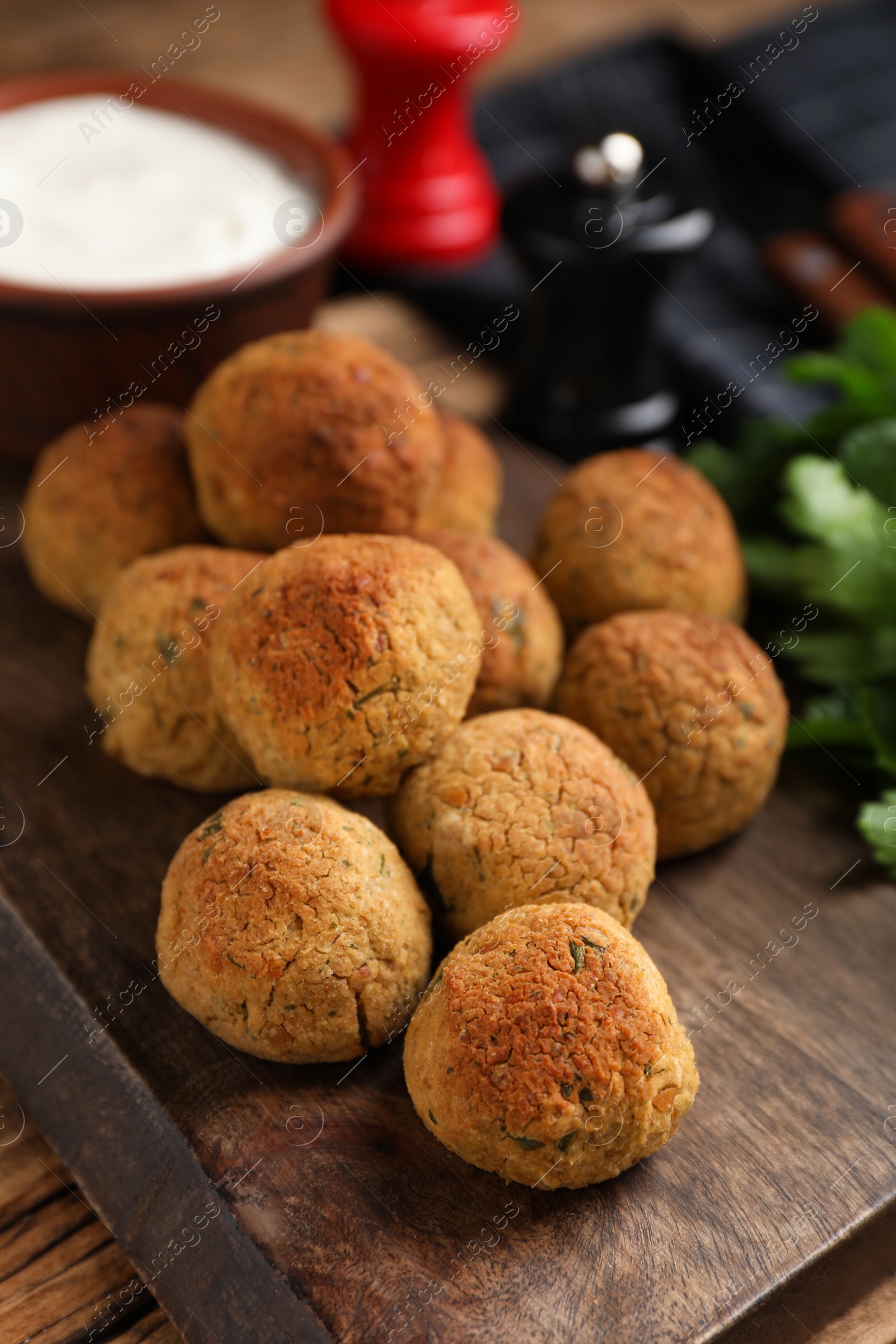 Photo of Delicious falafel balls on wooden table, closeup