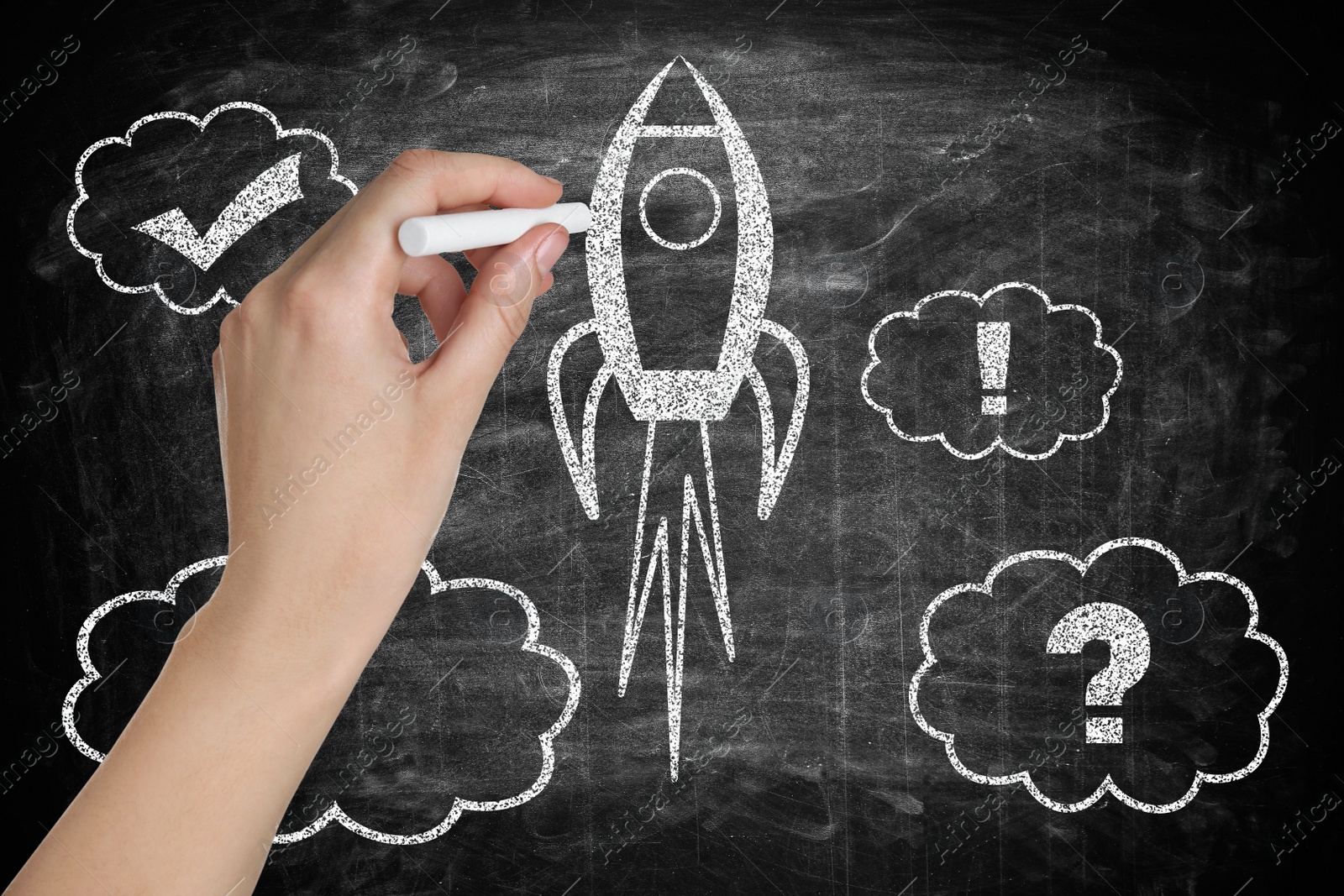 Image of Business startup concept. Woman drawing rocket on chalkboard, closeup