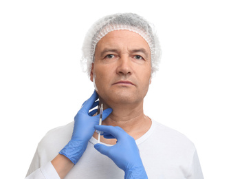 Mature man with double chin receiving injection on white background