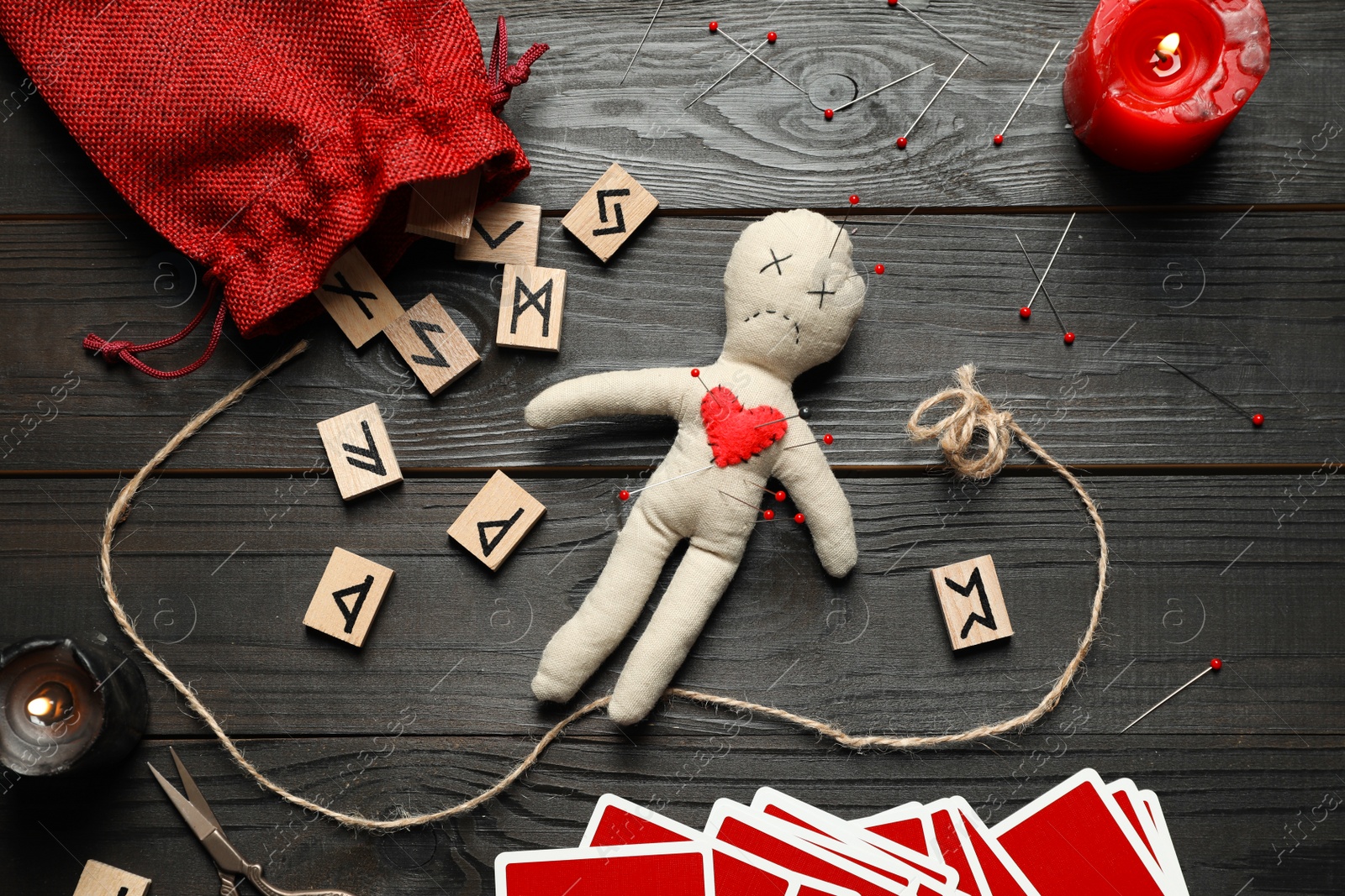 Photo of Flat lay composition with voodoo doll on dark wooden table