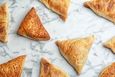 Photo of Flat lay composition with fresh delicious puff pastry on white marble table