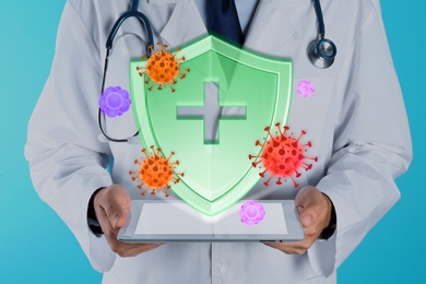 Image of Immunologist and shield with cross as symbol of virus protection on light blue background, closeup