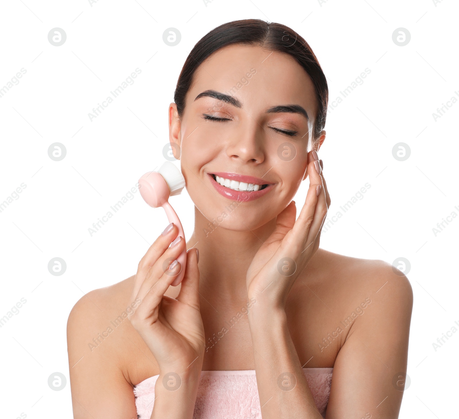 Photo of Young woman using facial cleansing brush on white background. Washing accessory