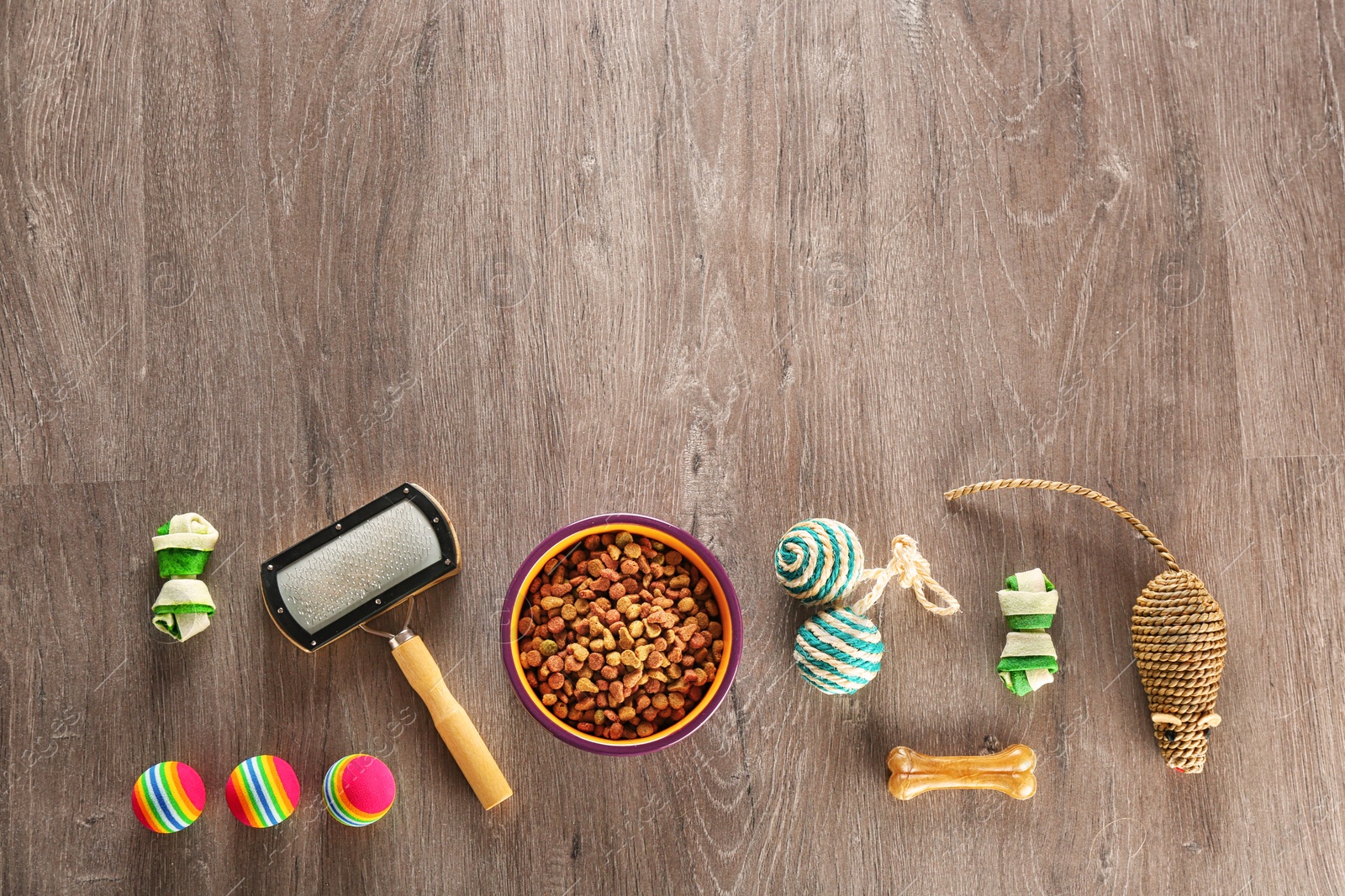 Photo of Flat lay composition with cat accessories and food on wooden background