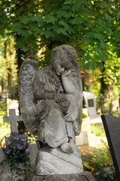 Photo of Beautiful statue of angel at cemetery on sunny day, space for text. Funeral ceremony