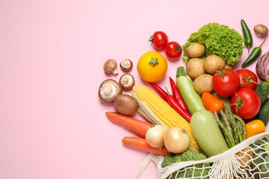 Different fresh vegetables on pink background, flat lay. Space for text