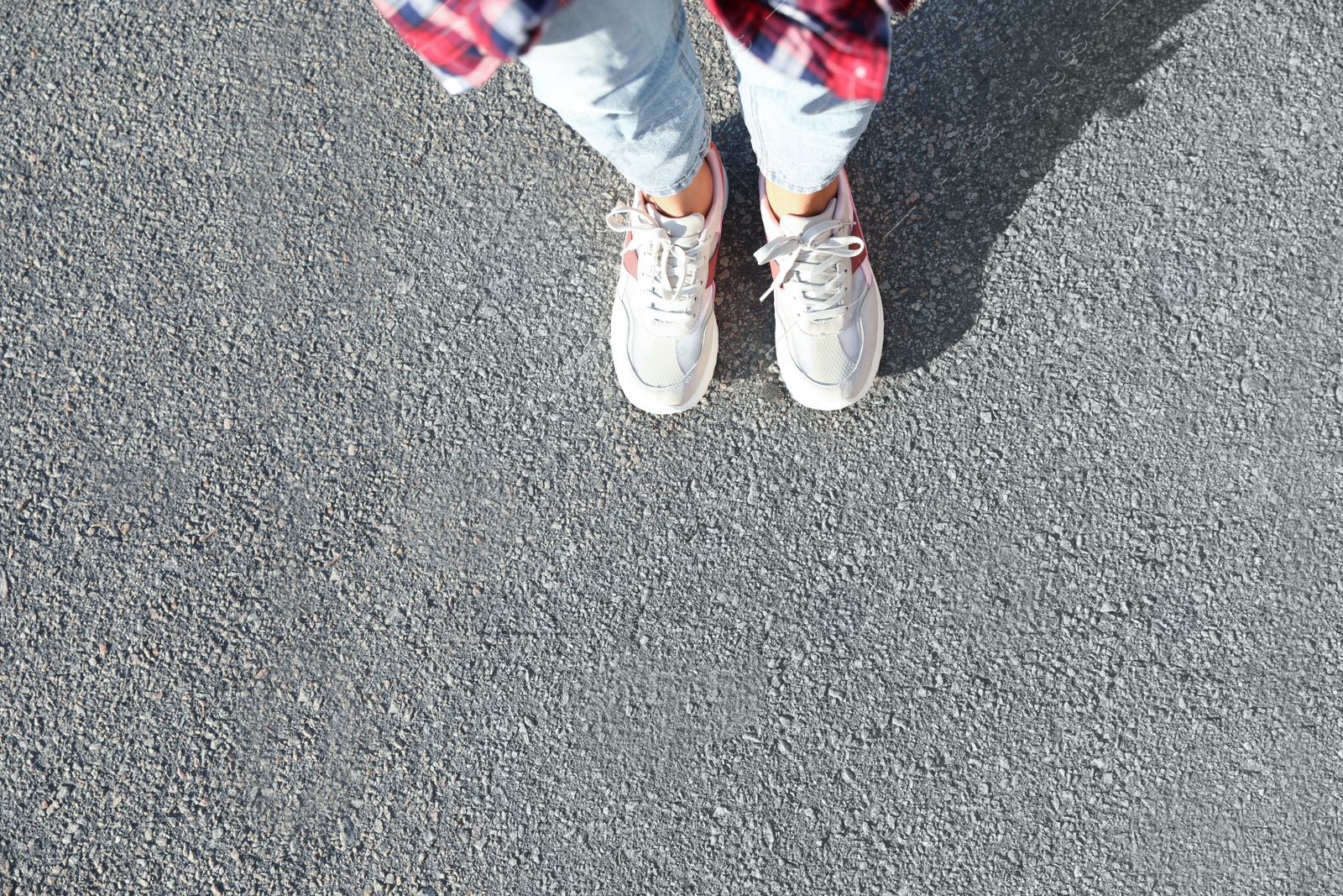 Photo of Woman standing outdoors, top view with space for text. Choosing way concept.