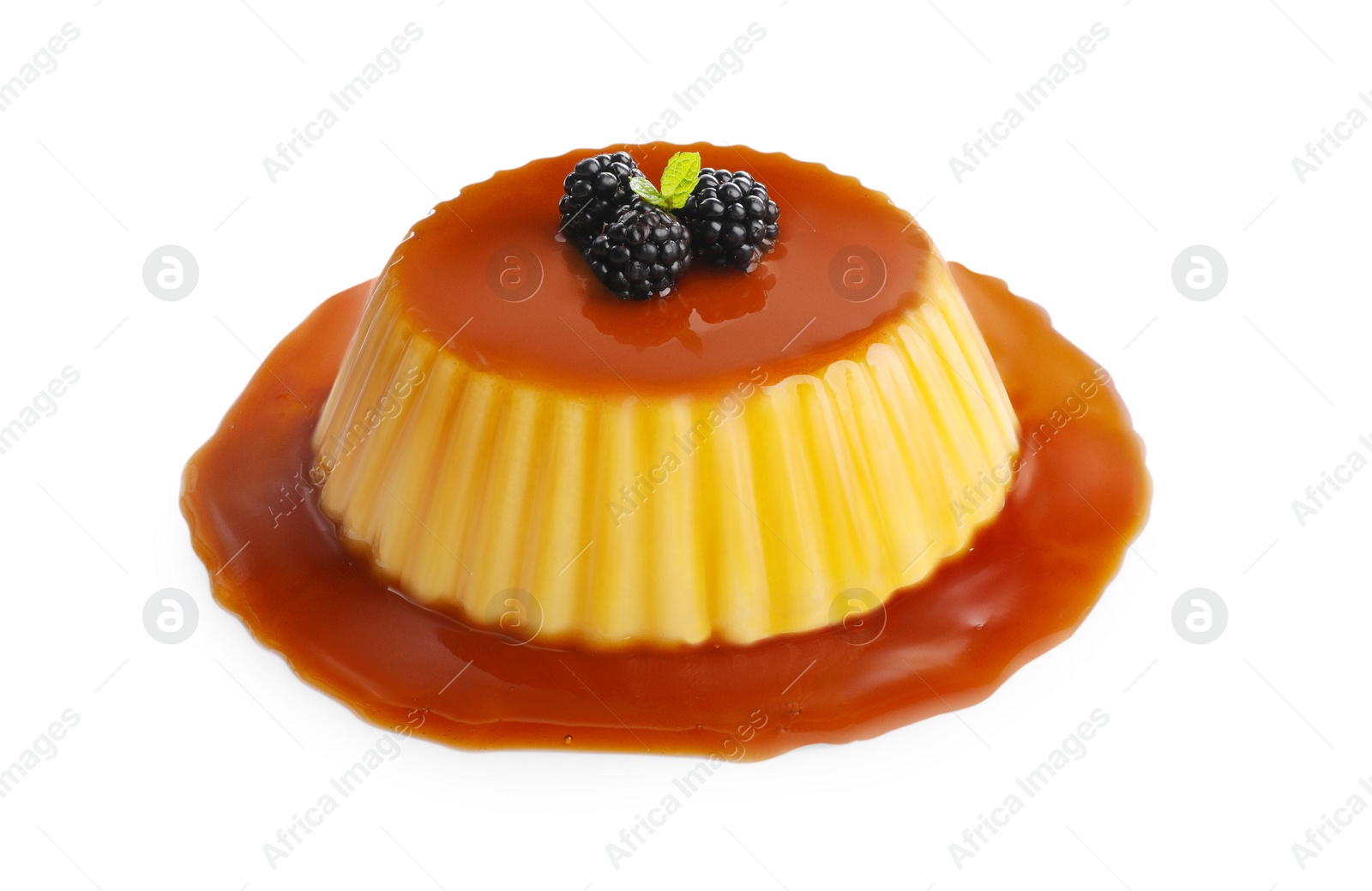 Photo of Delicious pudding with caramel and blackberries isolated on white
