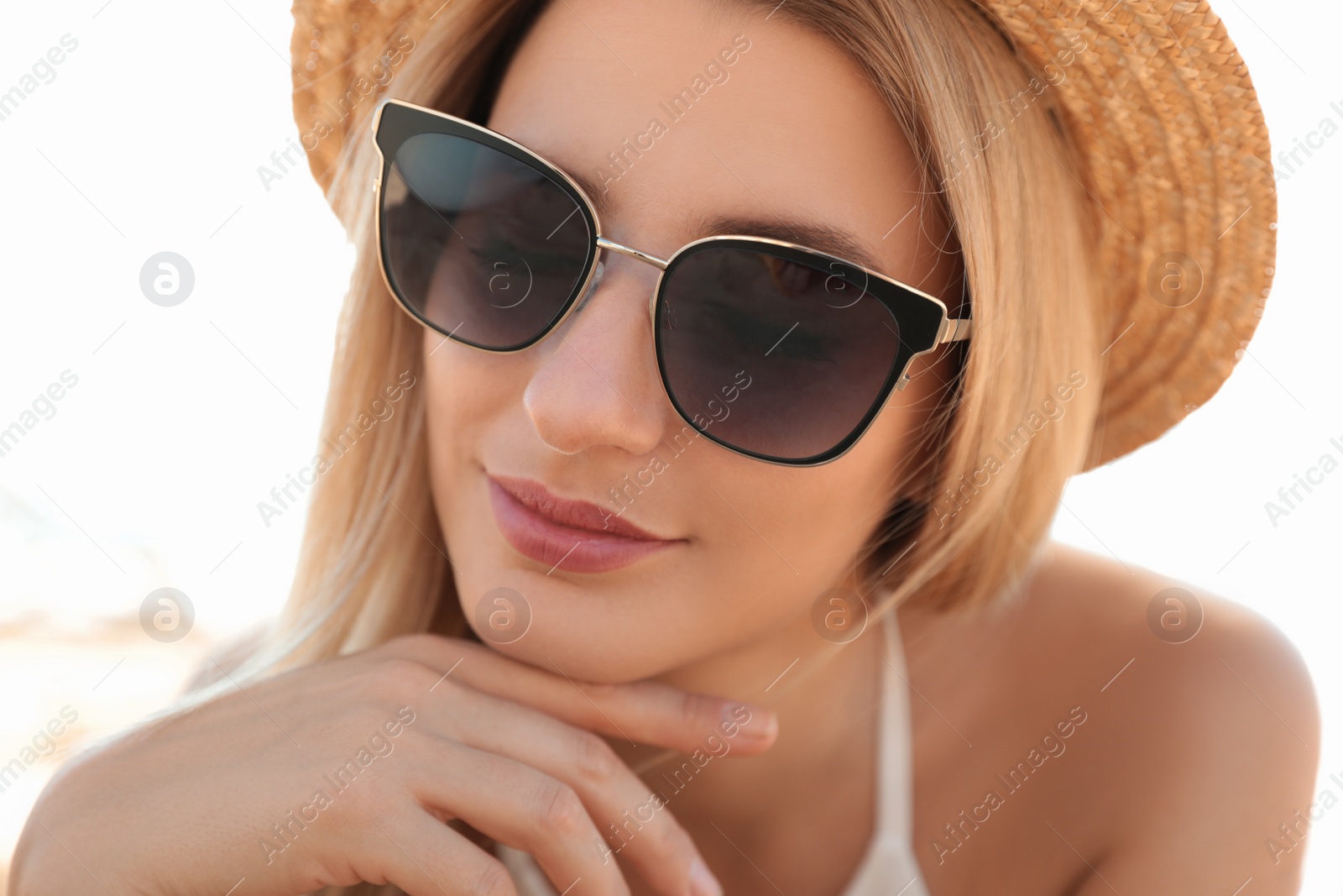 Photo of Beautiful woman wearing sunglasses outdoors on sunny day, closeup