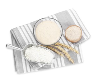 Photo of Leaven, flour and ears of wheat isolated on white, top view