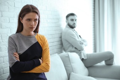 Image of Unhappy young couple with relationship problems at home, focus on woman. Cheating and breakup