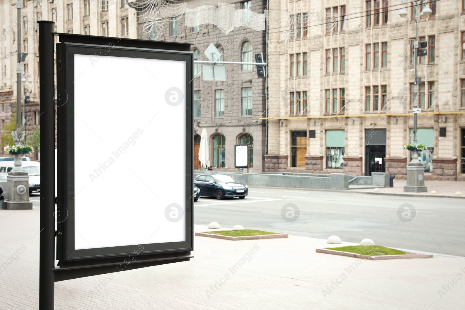 Photo of Blank advertising board on city street. Space for design