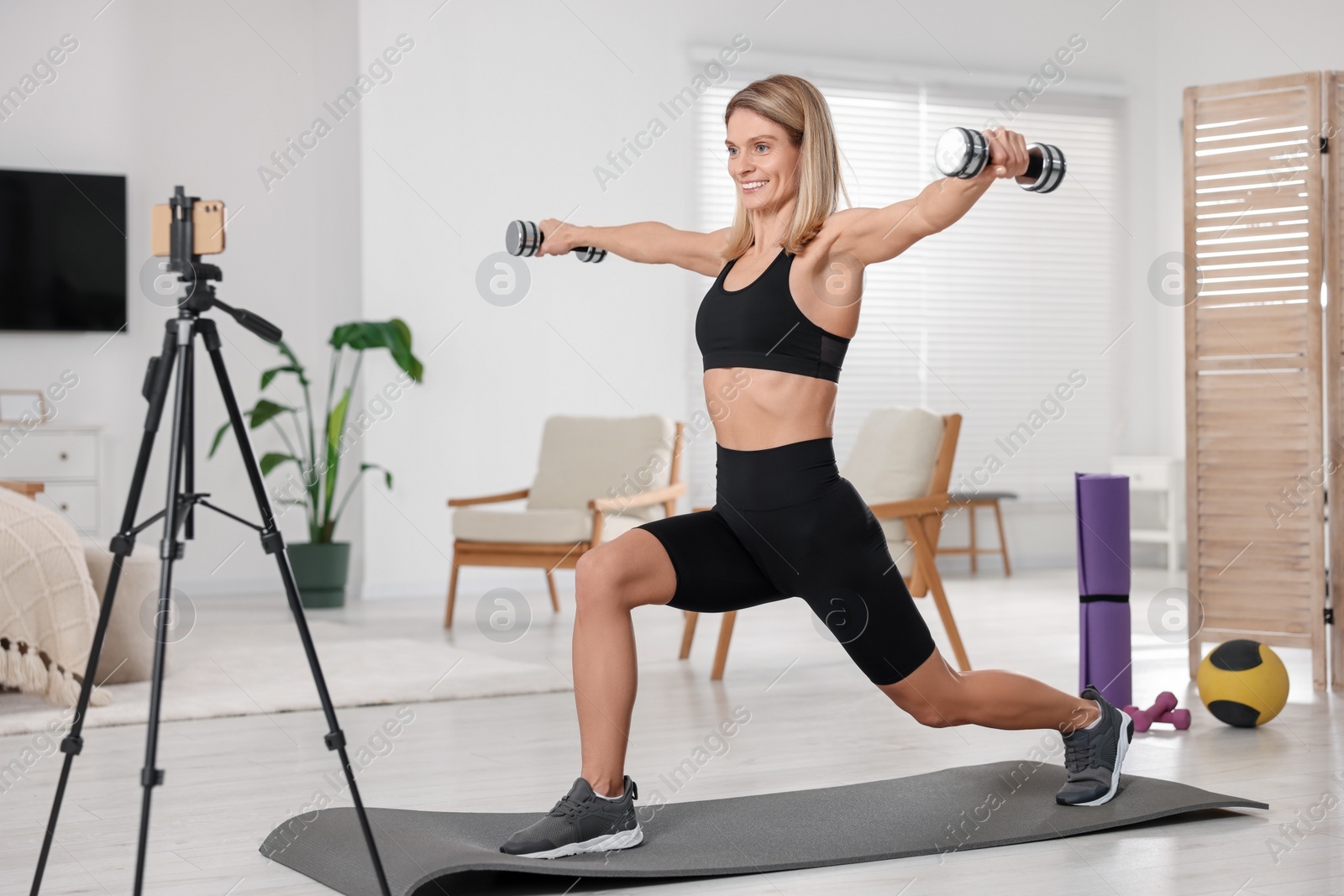 Photo of Fitness trainer recording online classes at home