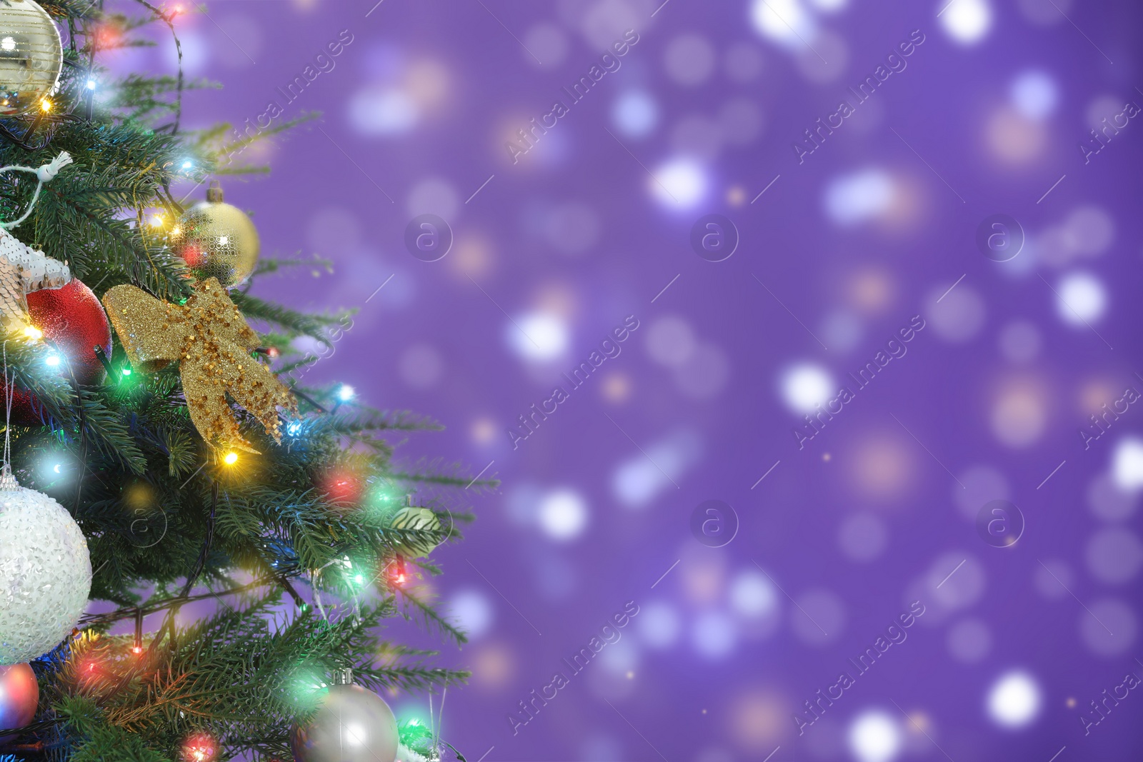 Image of Beautiful Christmas tree with bright baubles against blurred lights on violet background, closeup. Space for text