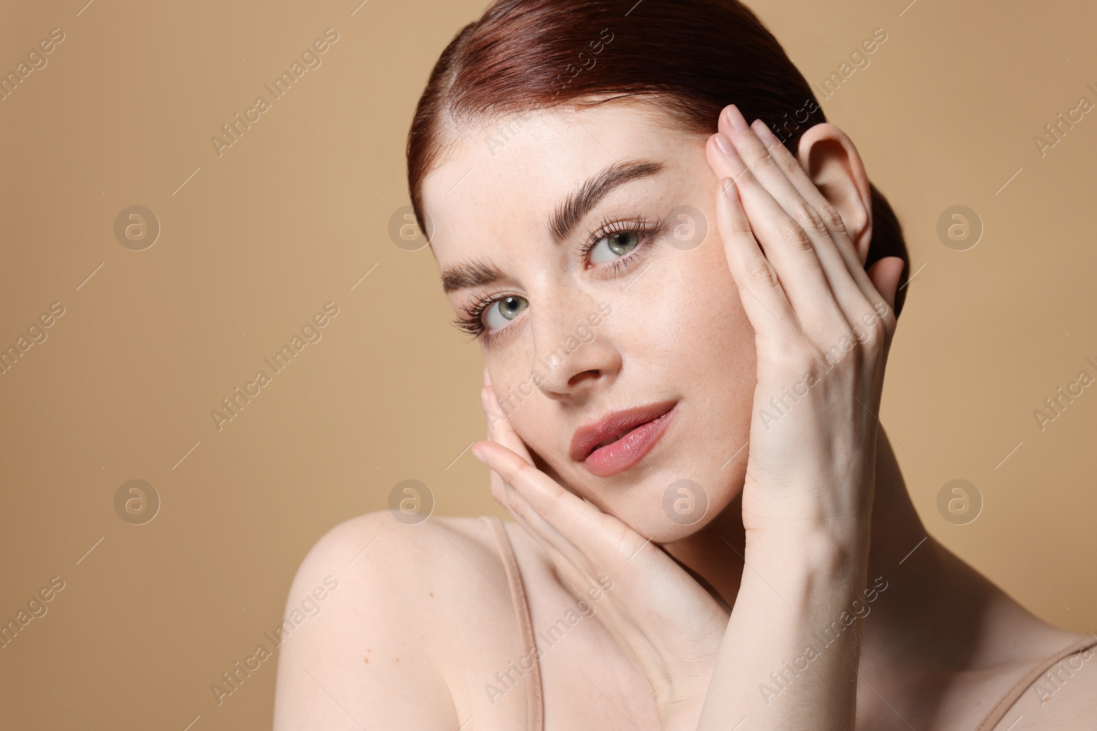 Photo of Portrait of beautiful woman on beige background, closeup